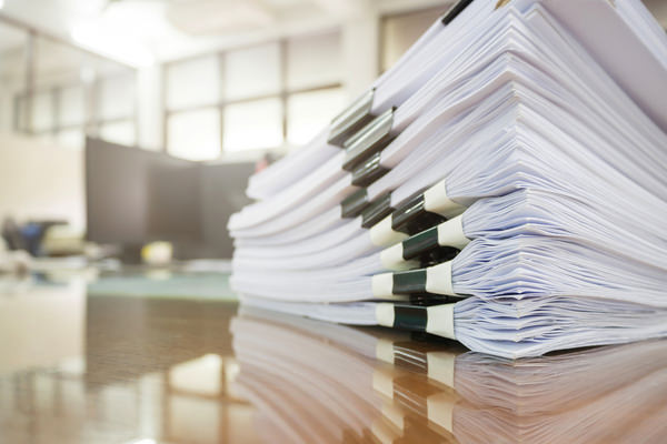 A stack of papers sitting on a desk